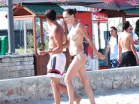 Holding a Paddle Ball Racket Among Beach Umbrellas