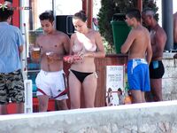 Holding a Paddle Ball Racket Among Beach Umbrellas