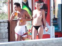 Holding a Paddle Ball Racket Among Beach Umbrellas