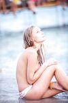 Topless Beach Stand in Patterned Bikini Bottoms by the Sea
