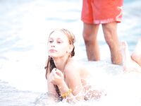 Topless Beach Stand in Patterned Bikini Bottoms by the Sea