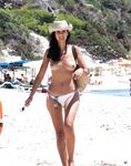 The sensation of the sun and sea air on a bare, topless figure. 2