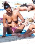 The sensation of the sun and sea air on a bare, topless figure. 2