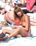 The sensation of the sun and sea air on a bare, topless figure. 2