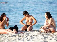. The soft texture of the sand and the warmth of a sun-drenched bare body.