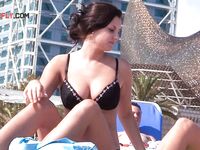 Two Women Topless on a City Beach by Apartments