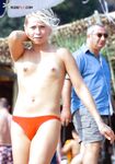 A lady enjoying the scenic coastal views in a relaxed, topless European style. 7