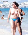 A model relaxing in the warm sand in a natural, completely nude state. 4