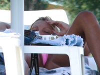 A lady enjoying the calm of a secluded bay in a topless fashion.