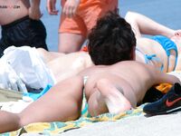 A lady enjoying the calm of a secluded bay in a topless fashion.