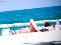 Orange Headband and a Magazine Near the Nude Beach Shoreline