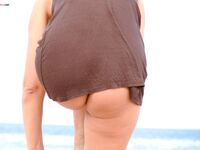 The artistic appeal of bare skin and white sand at a naturist beach.