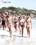 Finding serenity in a private cove, away from the crowds, enjoying the sun topless. 2