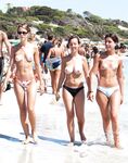 Finding serenity in a private cove, away from the crowds, enjoying the sun topless. 2