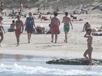 Nude Beach Shoreline with Waves Splashing at the Ankles
