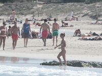 Nude Beach Shoreline with Waves Splashing at the Ankles