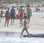 Nude Beach Shoreline with Waves Splashing at the Ankles