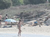 Nude Beach Shoreline with Waves Splashing at the Ankles