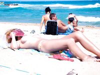 Water Dripping as She Steps From Rocky Nude Beach Shallows