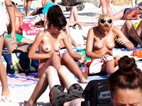 Enjoying the rhythmic sound of the waves while relaxing topless on a private towel. 2