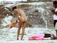 Stepping From the Shallow Surf in White Bikini Bottoms and a Cap