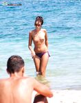 . Capturing the radiant glow of a sun-lover at a clothing-free beach. 2