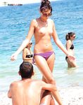 . Capturing the radiant glow of a sun-lover at a clothing-free beach. 2