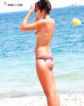 . Capturing the radiant glow of a sun-lover at a clothing-free beach. 2