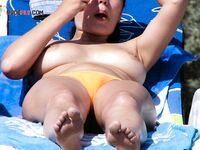 Posing Nude Outdoors with Red-Painted Fingernails