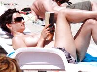Striped Headscarf and Topless Ease Beside a Seaside Cafe