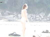 A Rear View Along the Bright Sunlit Nude Beach Shoreline