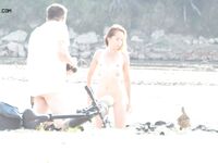 A Rear View Along the Bright Sunlit Nude Beach Shoreline