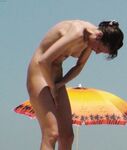 A Souvenir Photo Moment on the Open Nude Beach Sand