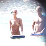 Book Open Nearby as Two Stand at a Rocky Mediterranean Shore