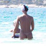 Book Open Nearby as Two Stand at a Rocky Mediterranean Shore