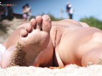 Easy Cross-Legged Laughter on Open Nude Beach Sand