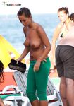 Topless Beach Sunbather in Floral Bikini Bottoms on Sand