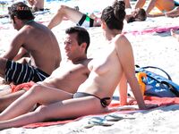 Loose Bun and a Relaxed Recline on a Busy Topless Beach