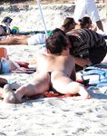 Loose Bun and a Relaxed Recline on a Busy Topless Beach