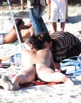 Loose Bun and a Relaxed Recline on a Busy Topless Beach