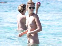 A lady finding her inner zen while sunbathing nude on a deserted shore. 6