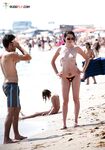A spontaneous topless shoot on a boardwalk overlooking the ocean waves. 4