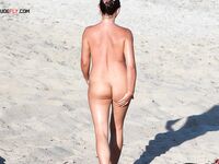 A Flower in Her Hair on a Barefoot Nude Beach Pause