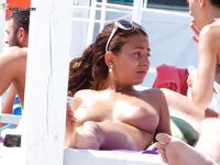 Finding the perfect spot for sunbathing without a top on the golden sand. 8