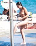 A Laughing Topless Moment on the Sand With Gear Close By
