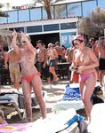 A Laughing Topless Moment on the Sand With Gear Close By