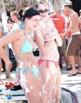 A Laughing Topless Moment on the Sand With Gear Close By