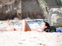 Rocky Cliffs and Gentle Surf in a Quiet Topless Beach Cove