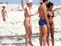 Face-Down Nude Tanning With Sand on Her Skin at the Beach