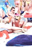 . The soft light of a new day warming a bare, sun-kissed bather by the sea. 2